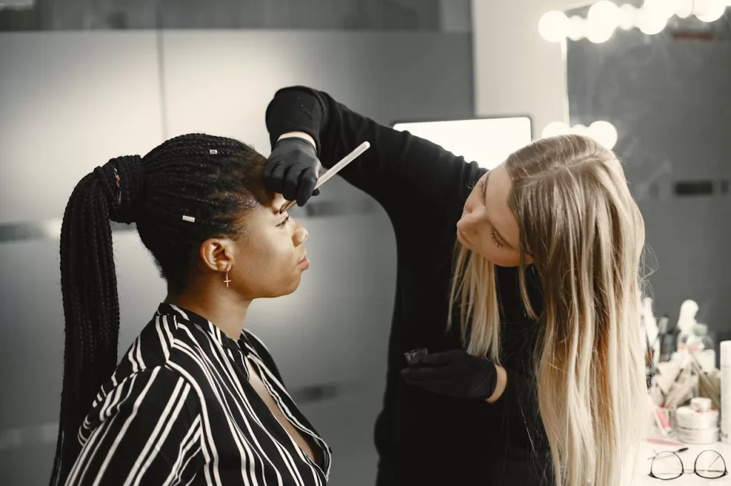 a nanoblading expert is working on the brows of a bride